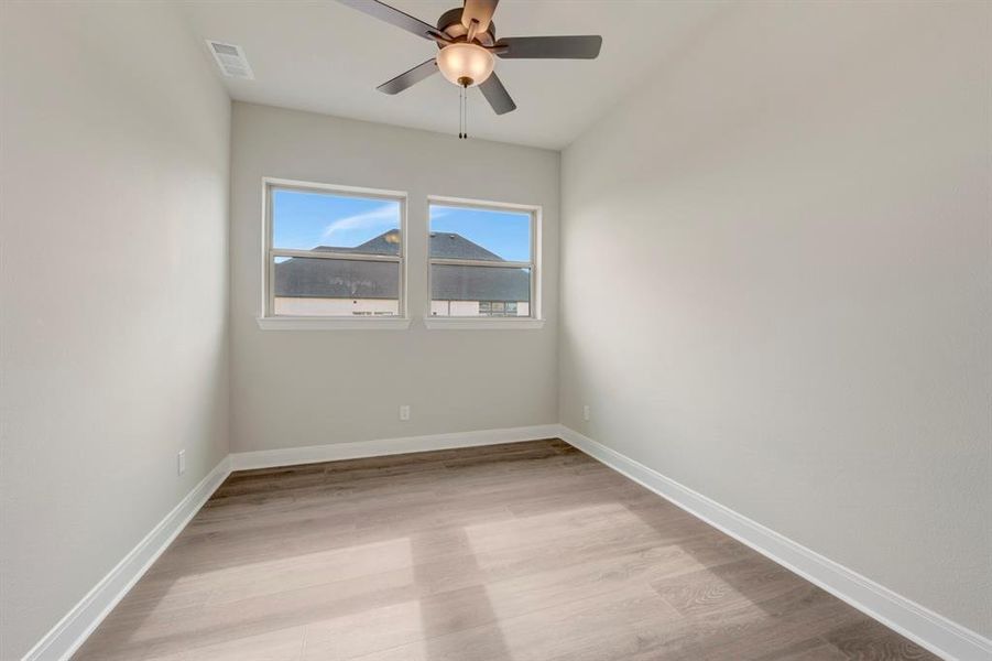 Unfurnished room with light wood finished floors and ceiling fan