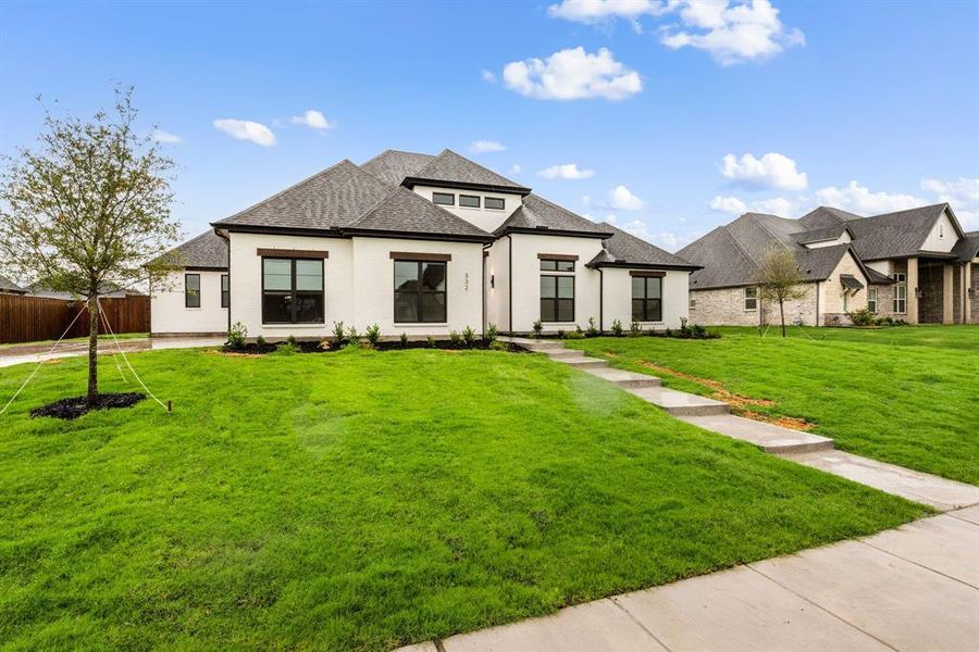 Front exterior of a new home in NorthGlen, Haslet, TX, highlighting curb appeal (Image 27).