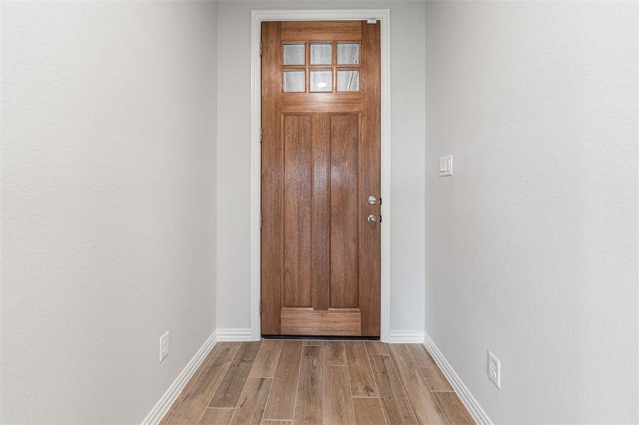 Entryway featuring wood finished floors and baseboards Entryway featuring wood finished floors and baseboards