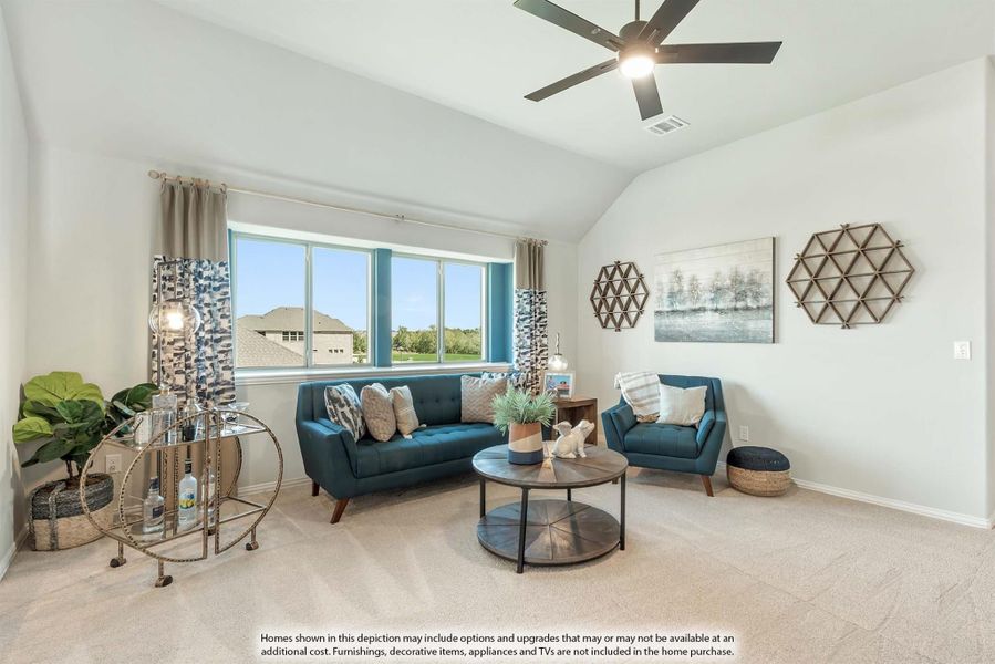 Living room with teal sofa and chair, vaulted ceiling, ceiling fan, and large windows with natural light Living room with teal sofa and chair, vaulted ceiling, ceiling fan, and large windows with natural light