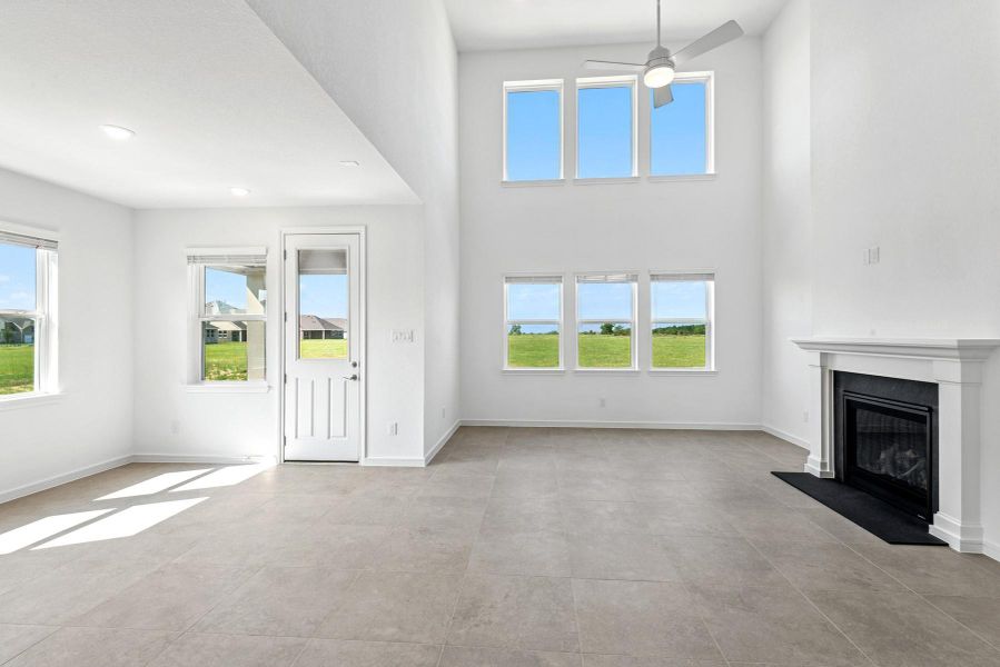 Impressive great room with fireplace and charming dining area (*Photo not of actual home and used for illustration purposes only.)