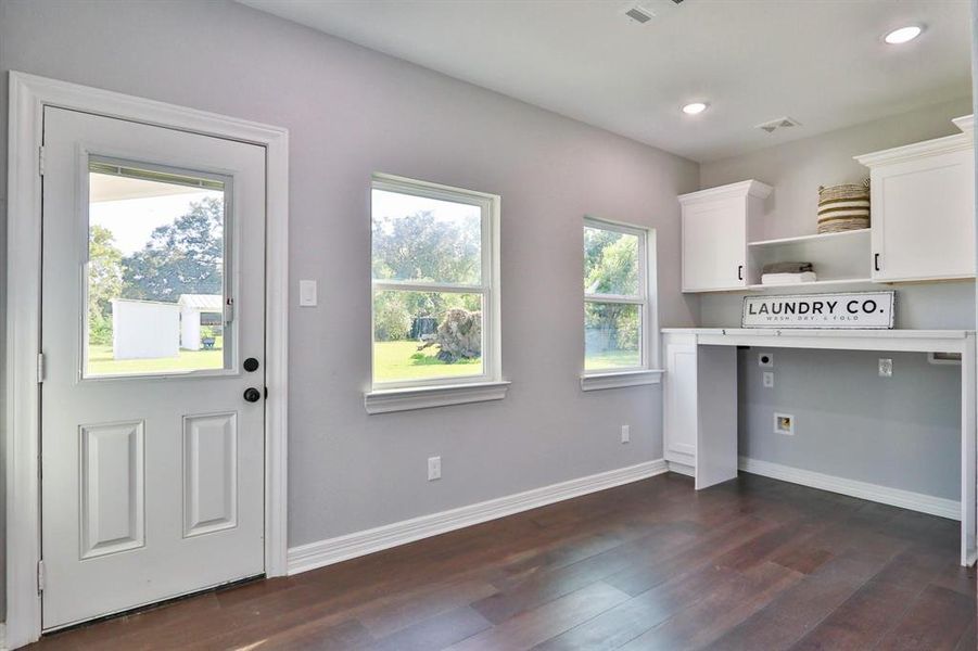 Laundry Has Never Been Move Fun! Huge utility room with storage cabinets/shelves and built-in folding table.