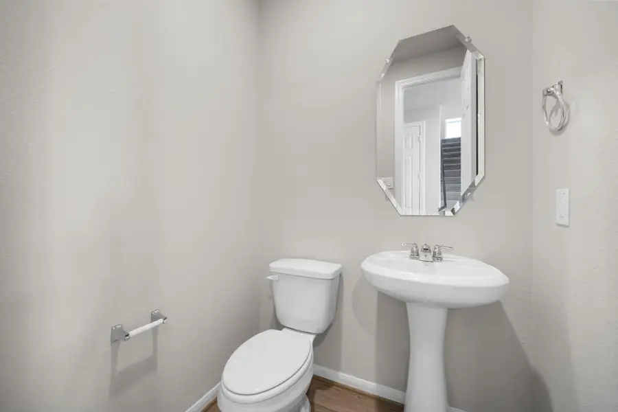 This charming home features a beautifully appointed half bath adjacent to the family room, perfect for welcoming guests and adding convenience to your daily life.