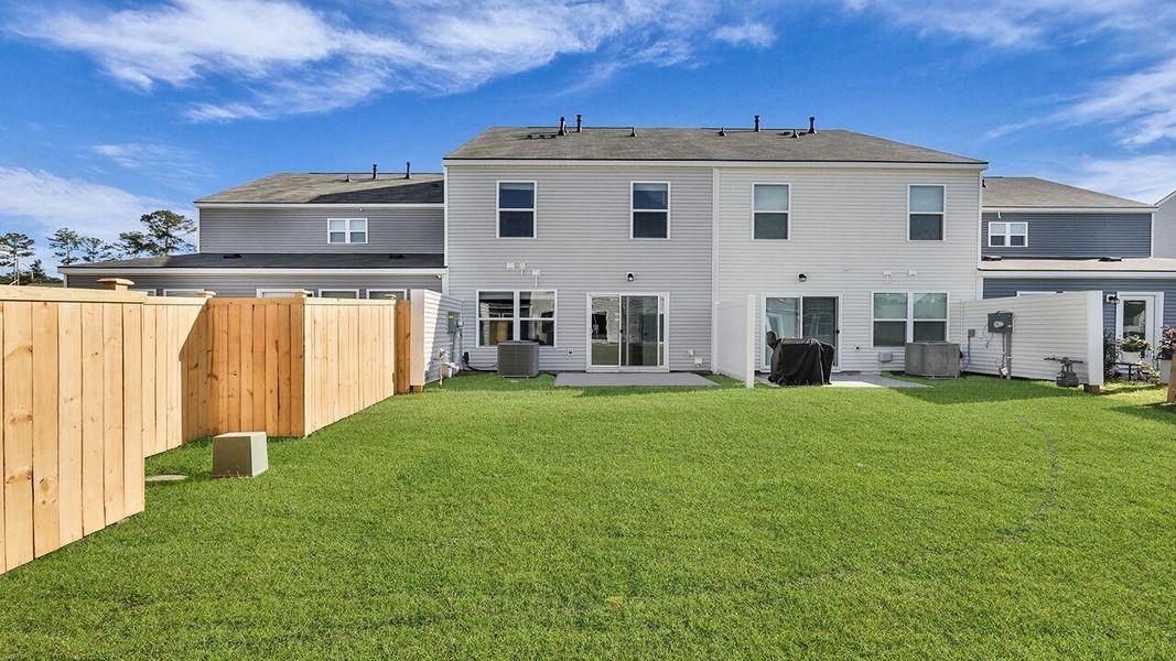 Exterior details and patio area of a home in Pine Hills Townhomes at Cane Bay, Summerville (Image 4).
