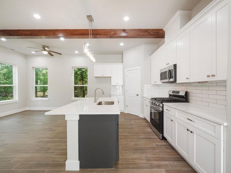 Kitchen is mix of navy blue island and white cabinets Kitchen is mix of navy blue island and white cabinets