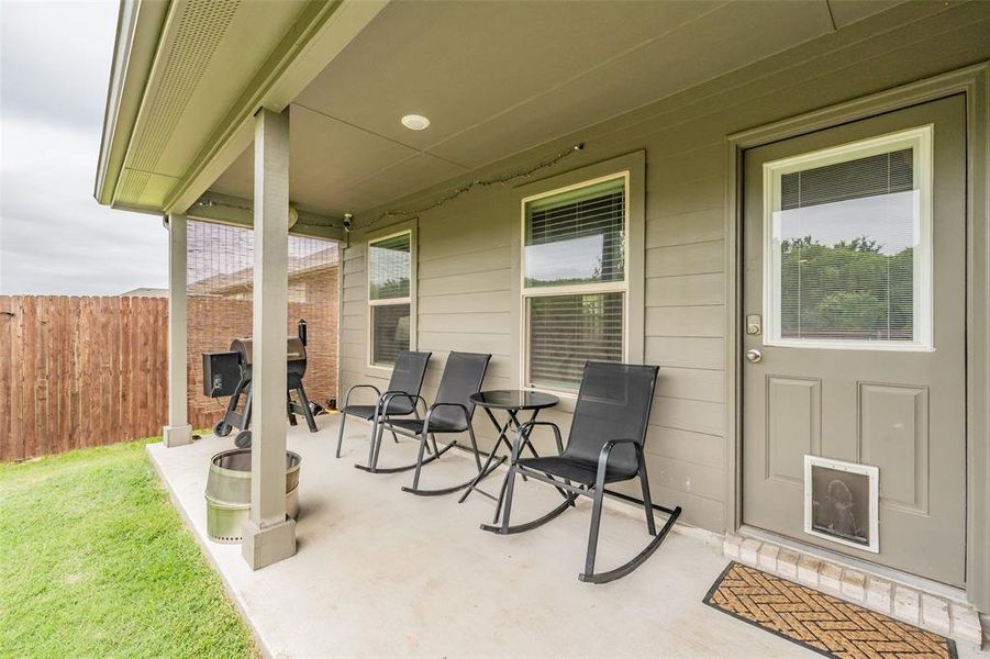 Covered patio with concrete flooring, recessed lighting, and a wood privacy fence