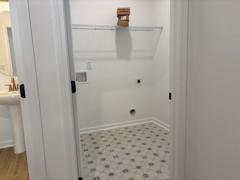 Laundry Room featuring the AW Collection® Serene - Light finishes and simple wire shelving.