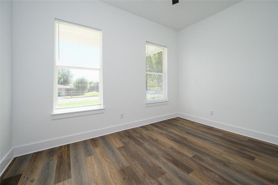 Empty room featuring dark hardwood / wood-style floors