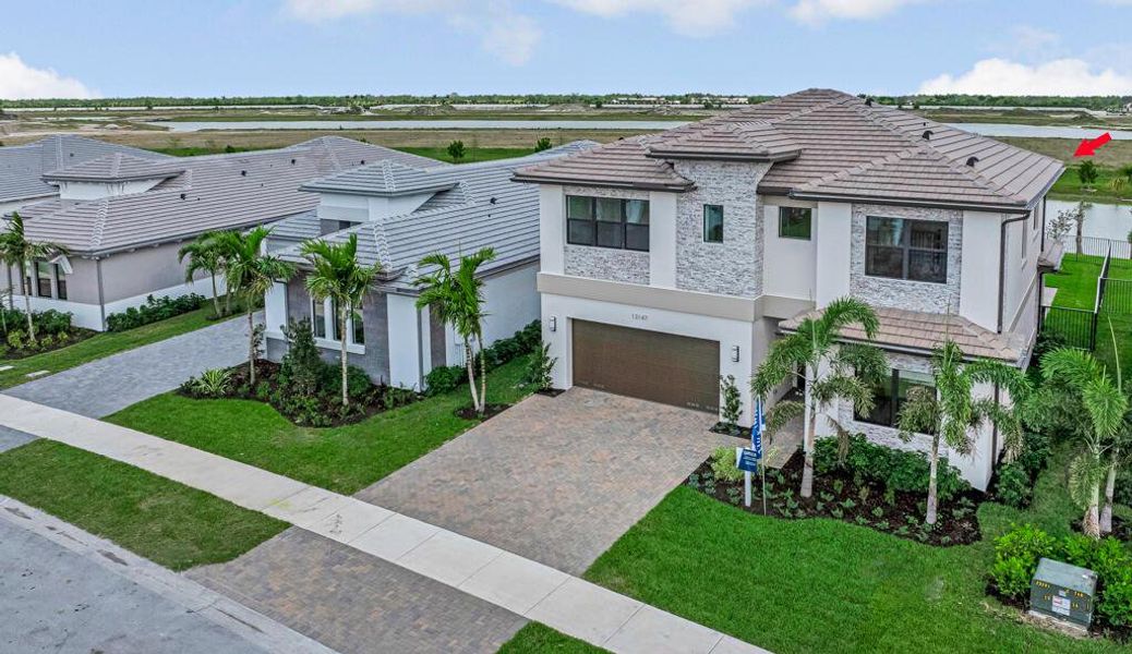 Front exterior of a new home in Apex at Avenir, Palm Beach Gardens, FL, highlighting curb appeal (Image 2).