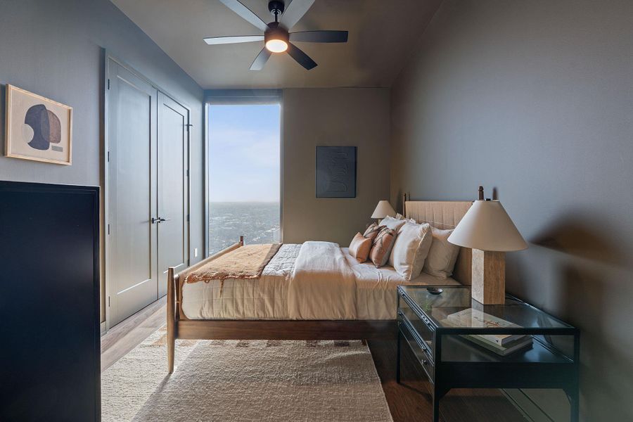 The guest room is an urban retreat that provides a beautiful slice of city life out the floor to ceiling window.