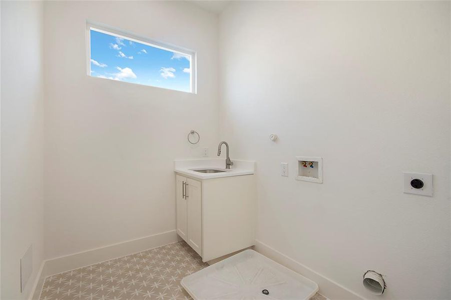 Laundry room featuring gas dryer hookup, washer hookup, cabinet space, hookup for an electric dryer, and light tile patterned floors
