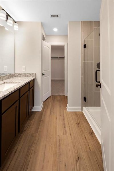 The color of the vinyl plank flooring and layout of the master bathroom is private and luxurious, like your favorite spa.