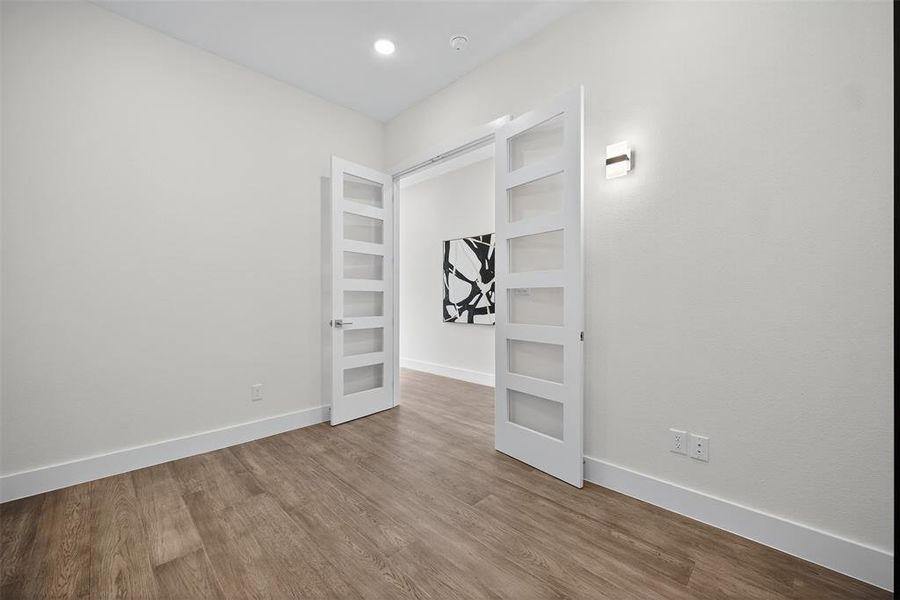 Unfurnished bedroom featuring wood finished floors and recessed lighting Unfurnished bedroom featuring wood finished floors and recessed lighting