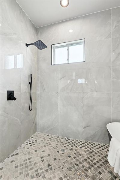 Bathroom featuring a tile shower