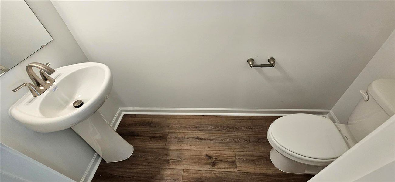This clean and bright powder room features a pedes This clean and bright powder room features a pedes