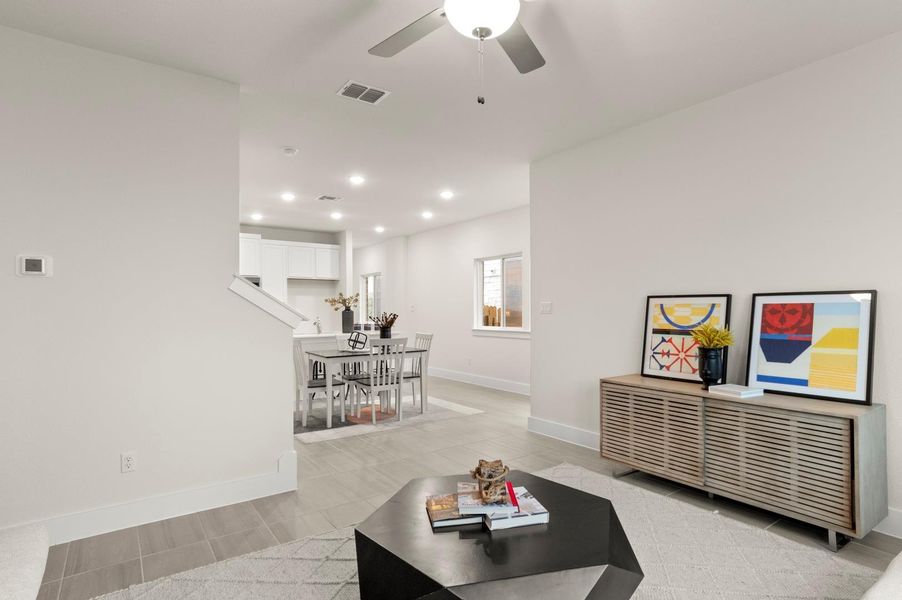 An open-concept living area seamlessly transitions into a bright dining space and a modern kitchen.