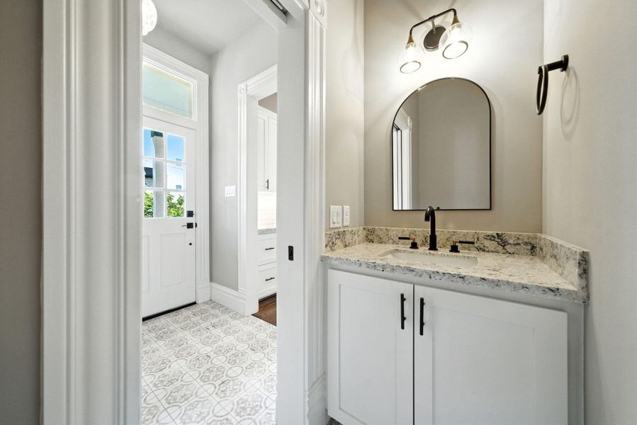 Half bath, just off the mudroom. Note the back door - access to / from the carport and backyard Half bath, just off the mudroom. Note the back door - access to / from the carport and backyard