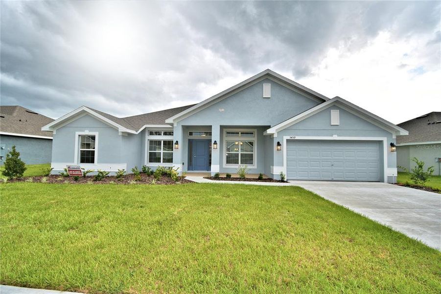 Front exterior of a new home in Cadence Crossing, Auburndale, FL, highlighting curb appeal (Image 1). Front exterior of a new home in Cadence Crossing, Auburndale, FL, highlighting curb appeal (Image 1).