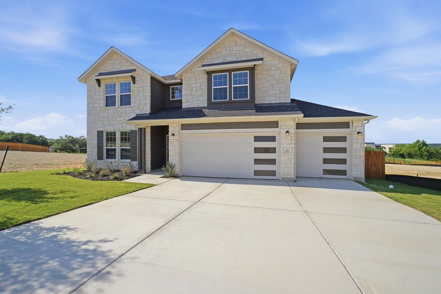 Front exterior of a new home in Lariat, Liberty Hill, TX, highlighting curb appeal (Image 2). Front exterior of a new home in Lariat, Liberty Hill, TX, highlighting curb appeal (Image 2).