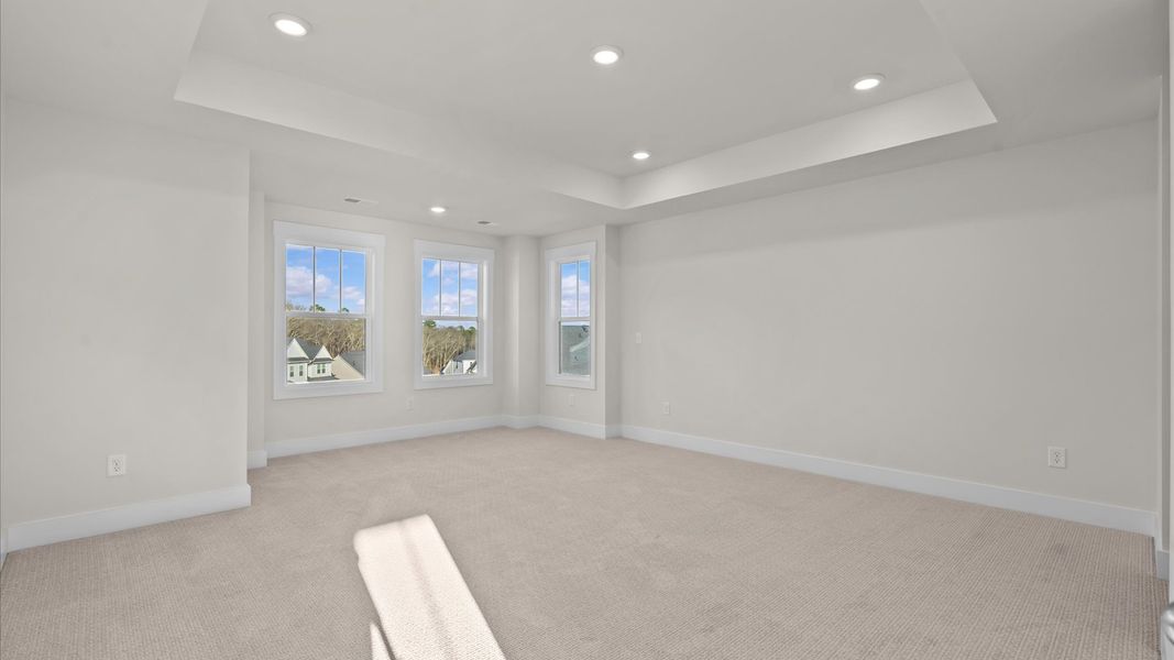 Exclusive upstairs retreat with a bright and airy primary suite with a walk-in closet and french doors