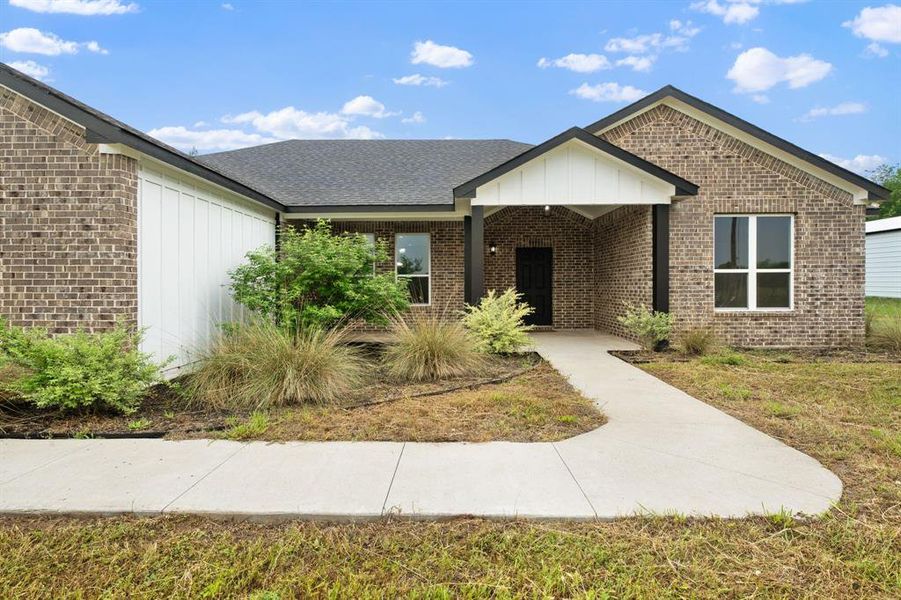 Front exterior of a new home in , Greenville, TX, highlighting curb appeal (Image 19).