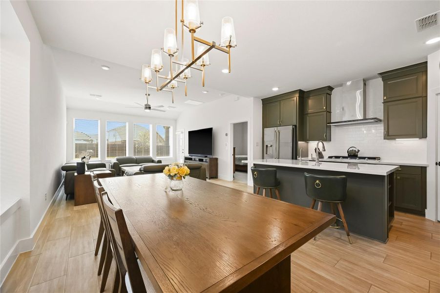 The dining room combines rich hardwood tile floors with a beautiful designer chandelier. The dining room combines rich hardwood tile floors with a beautiful designer chandelier.