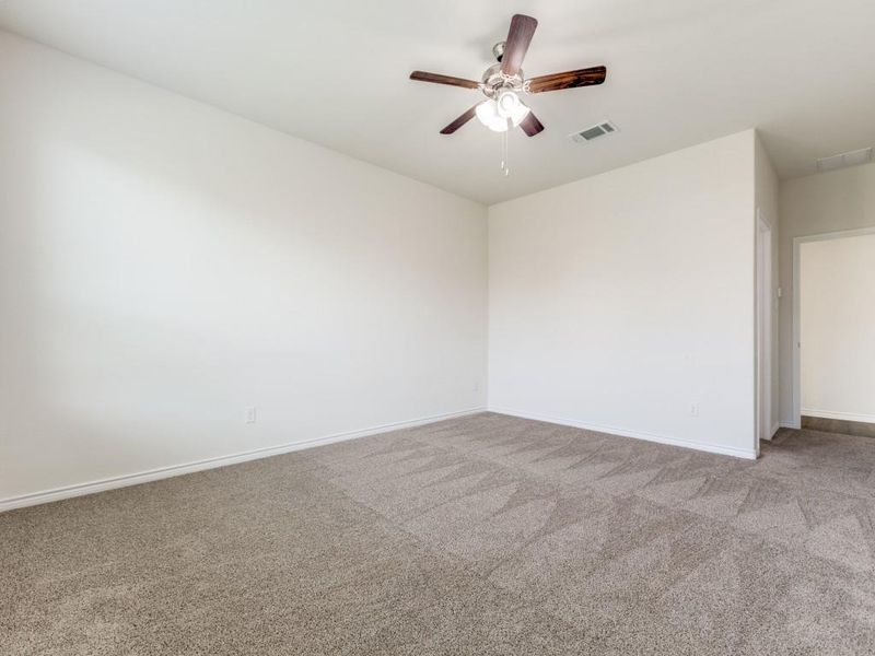 Carpeted bedroom room featuring baseboards and ceiling fan