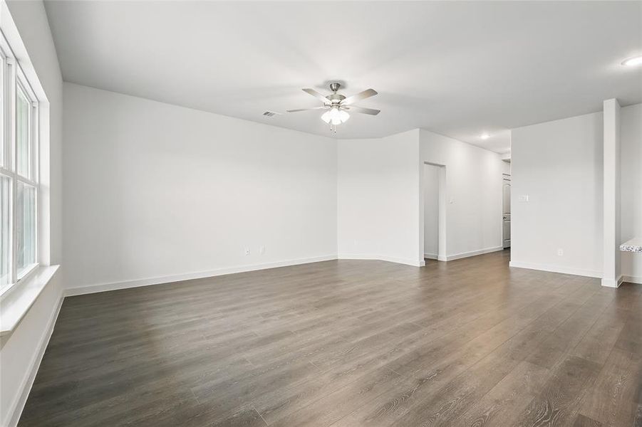 Spare room with dark wood-style flooring, a ceiling fan, and recessed lighting Spare room with dark wood-style flooring, a ceiling fan, and recessed lighting