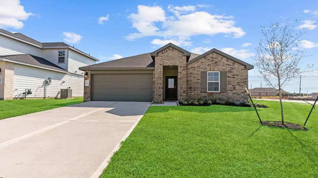 Front exterior of a new home in Evergreen, Rosenberg, TX, highlighting curb appeal (Image 1). Front exterior of a new home in Evergreen, Rosenberg, TX, highlighting curb appeal (Image 1).