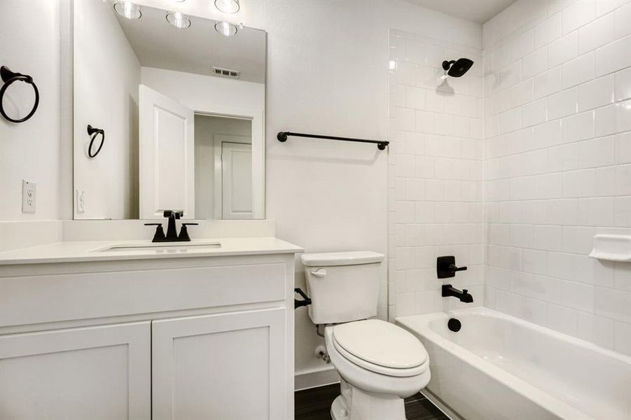 Full bathroom with shower / bath combination and vanity