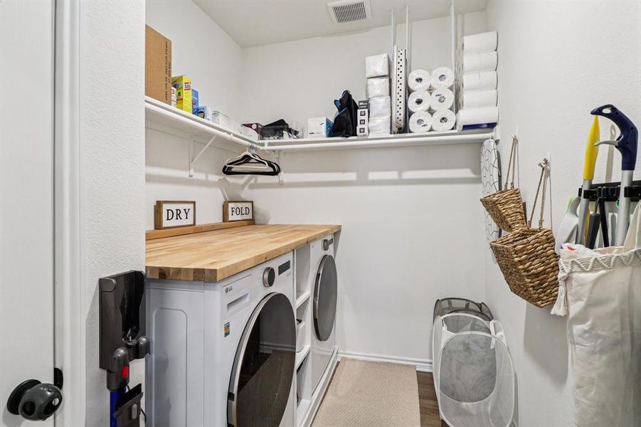 Washroom featuring washer and dryer and dark wood-style floors Washroom featuring washer and dryer and dark wood-style floors