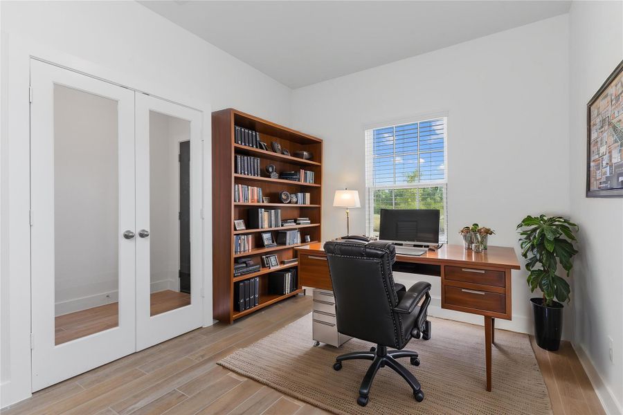 Virtually staged and privately tucked away, this home office is the perfect spot for focus and productivity. Large windows invite natural light, creating a bright and inspiring workspace. Virtually staged and privately tucked away, this home office is the perfect spot for focus and productivity. Large windows invite natural light, creating a bright and inspiring workspace.