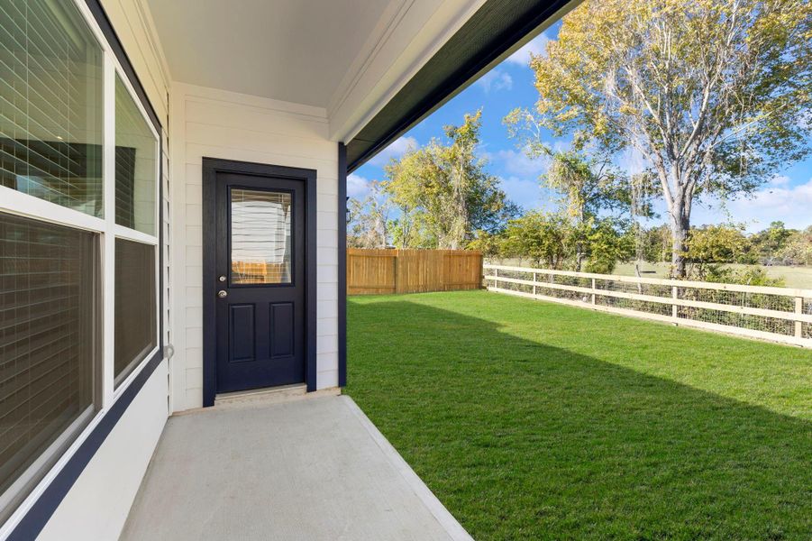 The backyard features a covered patio, perfect for relaxing.