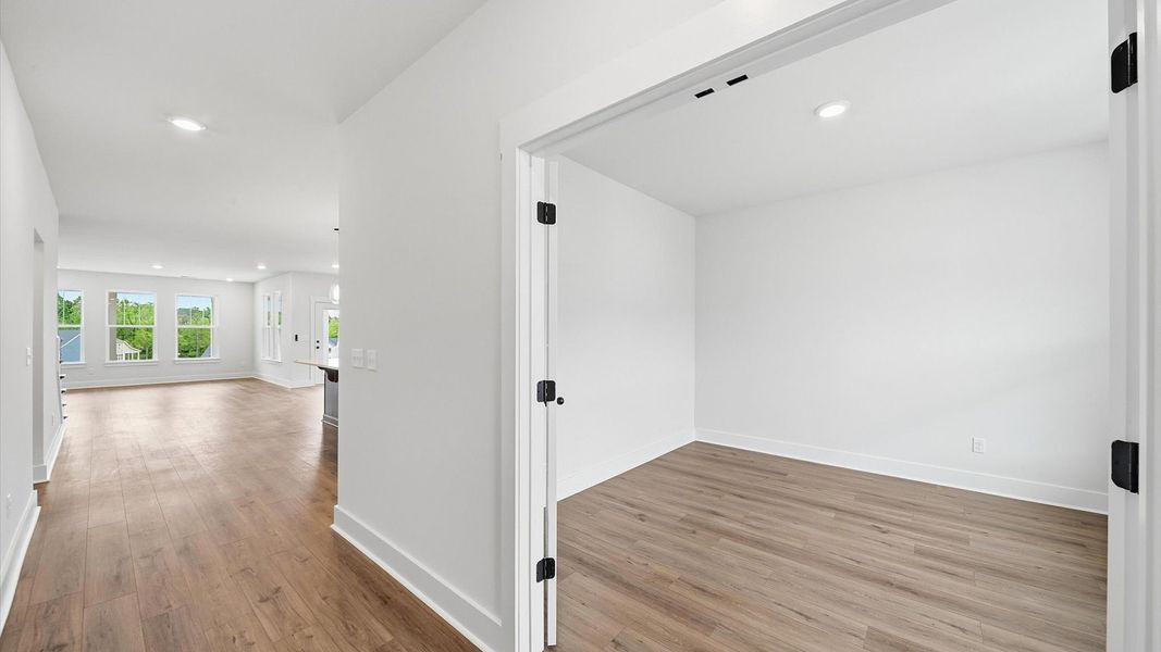 Notable hardwood flooring enhances the elegance of this accomplished entryway located at the Iris Meadows community