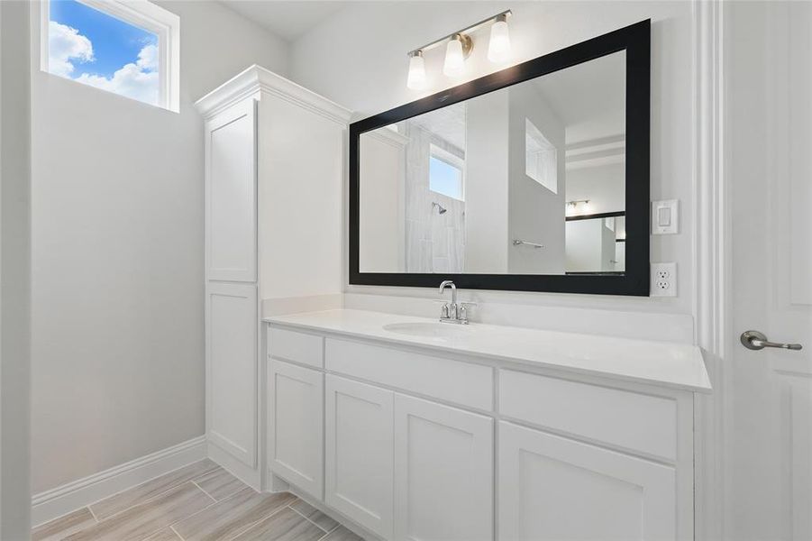 Full bath with vanity and baseboards Full bath with vanity and baseboards