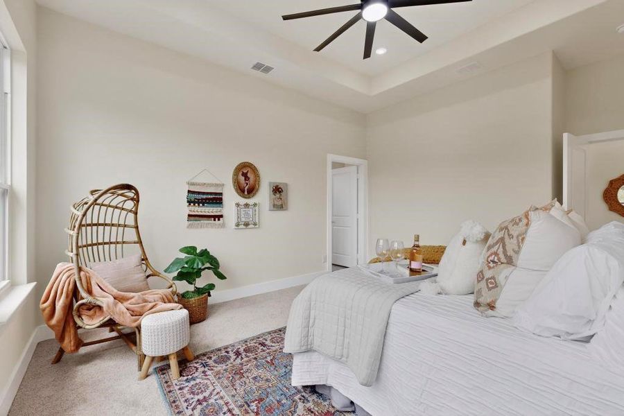 Bedroom with carpet, a ceiling fan, a raised ceiling, and recessed lighting Bedroom with carpet, a ceiling fan, a raised ceiling, and recessed lighting