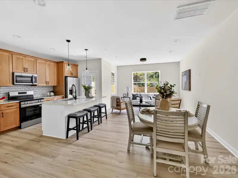 Open-concept kitchen flows seamlessly into a bright breakfast nook and living area, creating an inviting space ideal for both everyday dining and entertaining. Open-concept kitchen flows seamlessly into a bright breakfast nook and living area, creating an inviting space ideal for both everyday dining and entertaining.