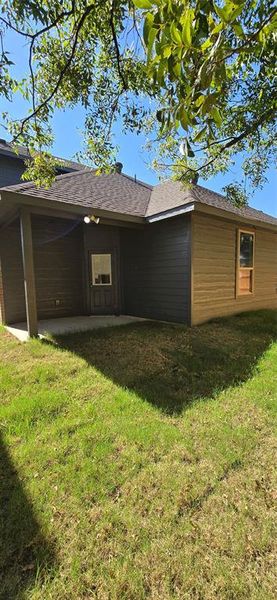 View of property exterior featuring a yard