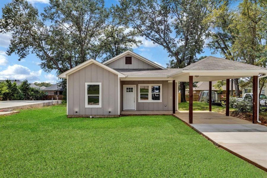 View of front of house with a carport, driveway, a shingled roof, board and batten siding, and a porch View of front of house with a carport, driveway, a shingled roof, board and batten siding, and a porch