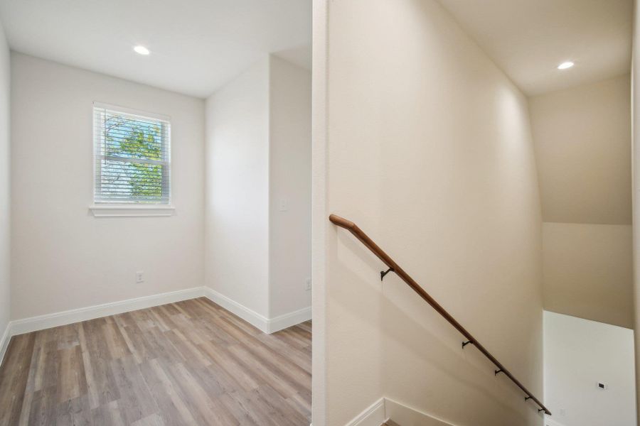 Stairway featuring recessed lighting, baseboards, and wood finished floors Stairway featuring recessed lighting, baseboards, and wood finished floors