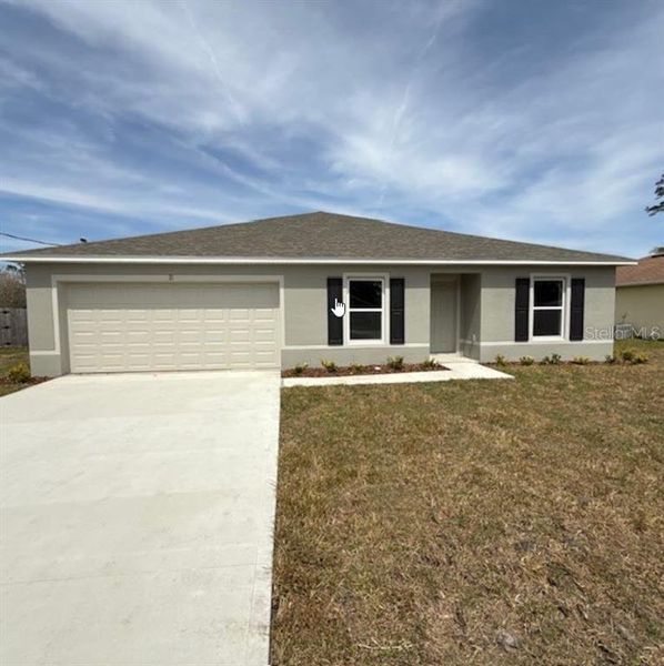 Front exterior of a new home in Palm Coast: Value Collection, Palm Coast, FL, highlighting curb appeal (Image 1).
