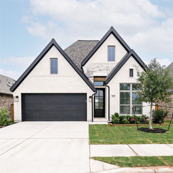 Front exterior of a new home in 6 Creeks, Kyle, TX, highlighting curb appeal (Image 7).