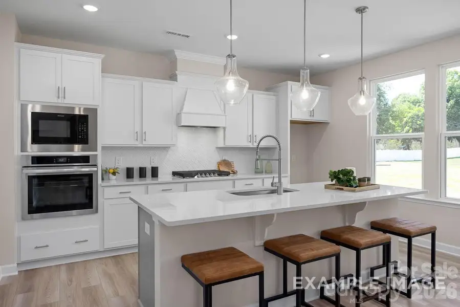 Actual home will have the gourmet kitchen layout with wall ovens and gas cooktop