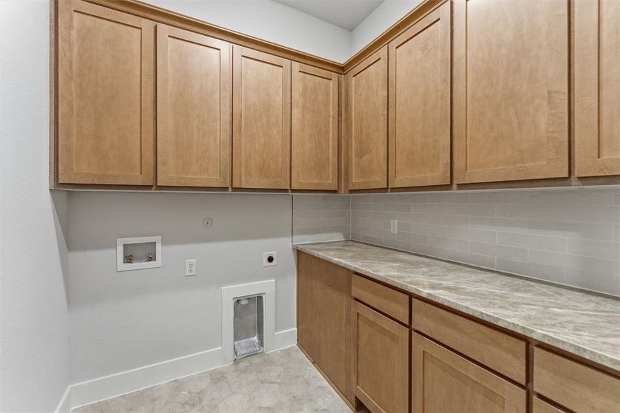 Laundry area with hookup for an electric dryer, hookup for a washing machine, and cabinet space Laundry area with hookup for an electric dryer, hookup for a washing machine, and cabinet space