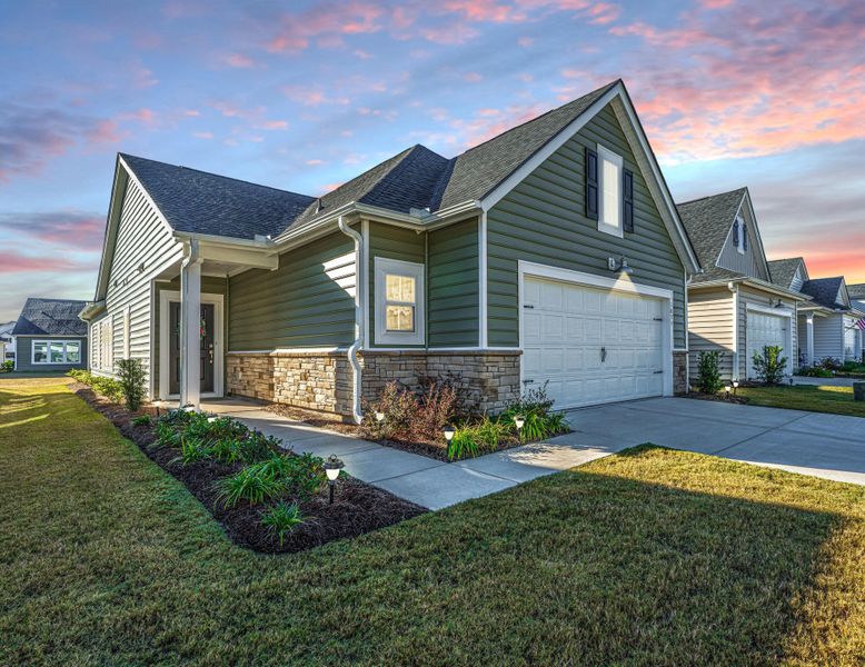 Front exterior of a new home in Horizons at Summers Corner | 55+: The Cottages, Summerville, SC, highlighting curb appeal (Image 16).