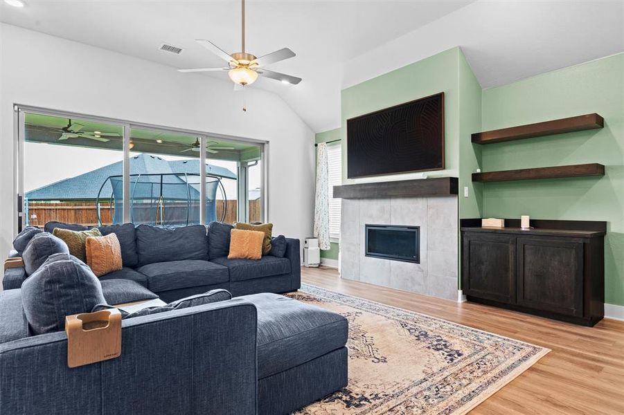 The living room is large and provides a cozy fireplace and huge patio doors that provide abundant natural light.