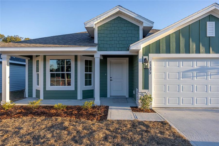 Front exterior of a new home in Briarwood, Alachua, FL, highlighting curb appeal (Image 16).