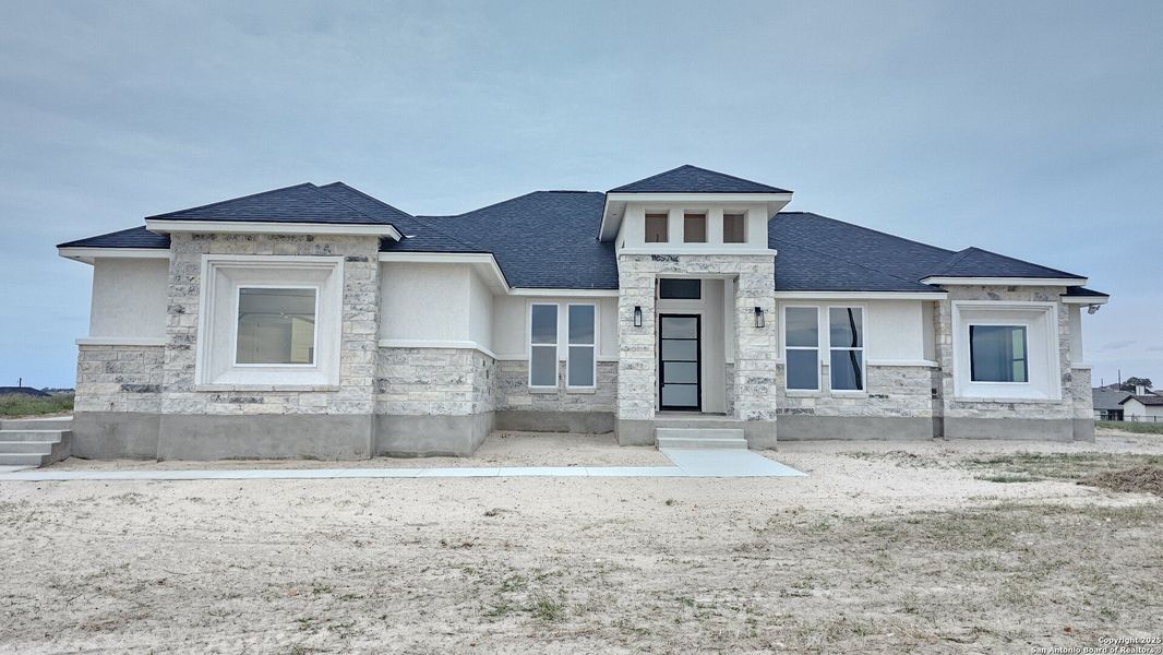 Front exterior of a new home in , La Vernia, TX, highlighting curb appeal (Image 22).