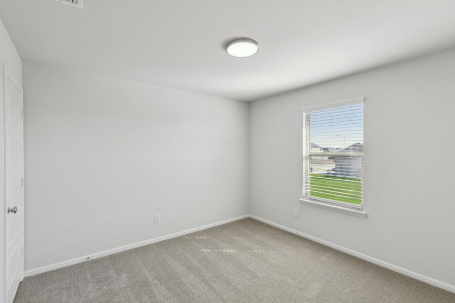 Bedroom in the Holden home plan by Trophy Signature Homes – REPRESENTATIVE PHOTO