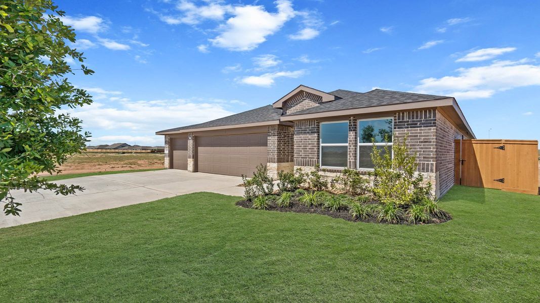Front exterior of a new home in Sunterra Lakes, Brookshire, TX, highlighting curb appeal (Image 2). Front exterior of a new home in Sunterra Lakes, Brookshire, TX, highlighting curb appeal (Image 2).